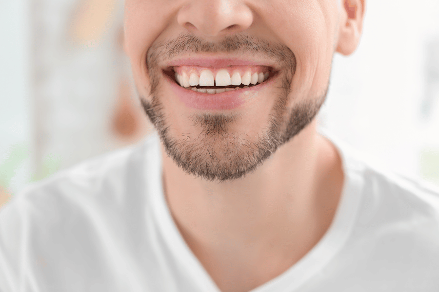 Man smiling, showing gapped teeth
